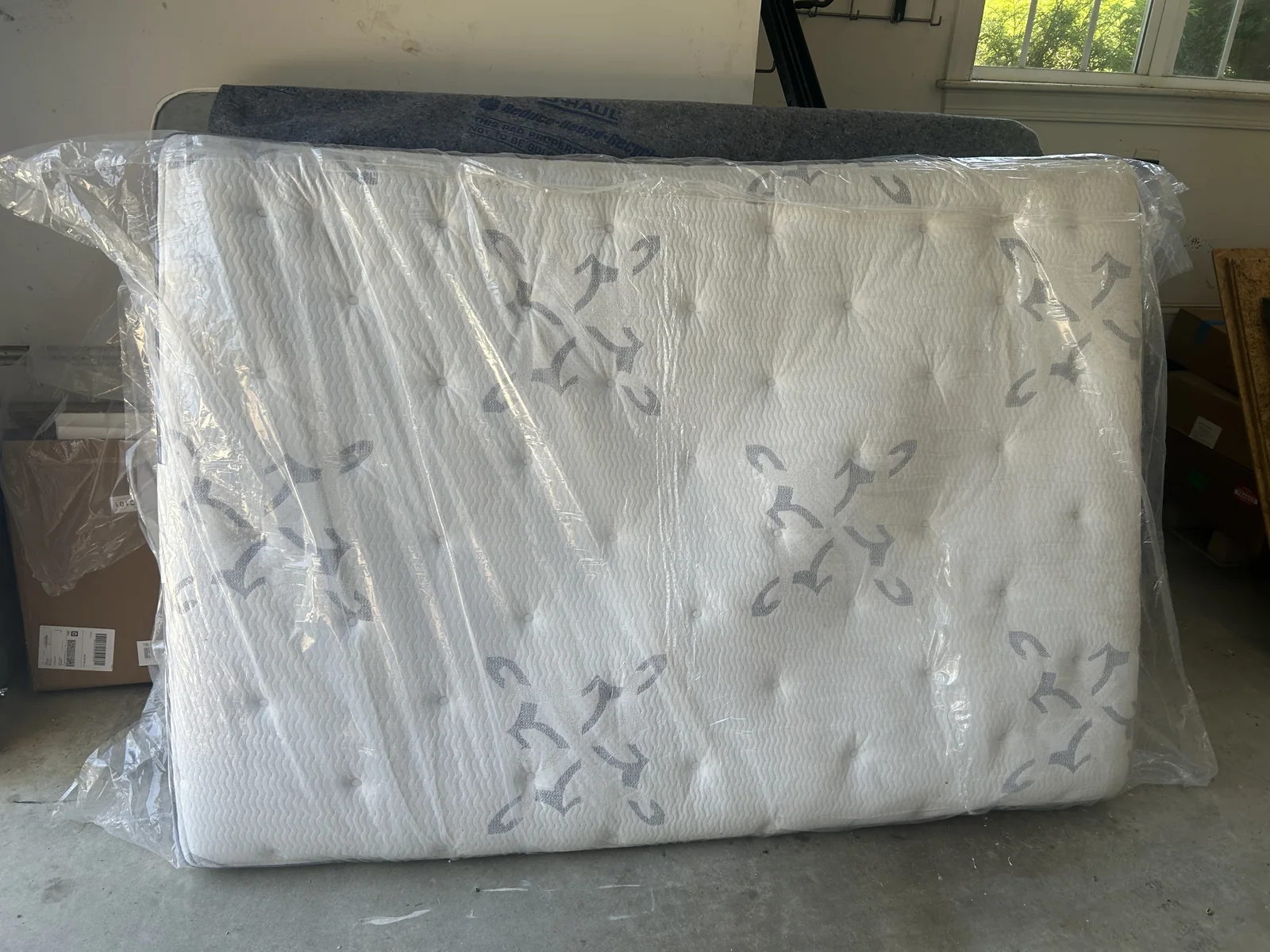 Mattress standing in a garage ready for ACG to haul away