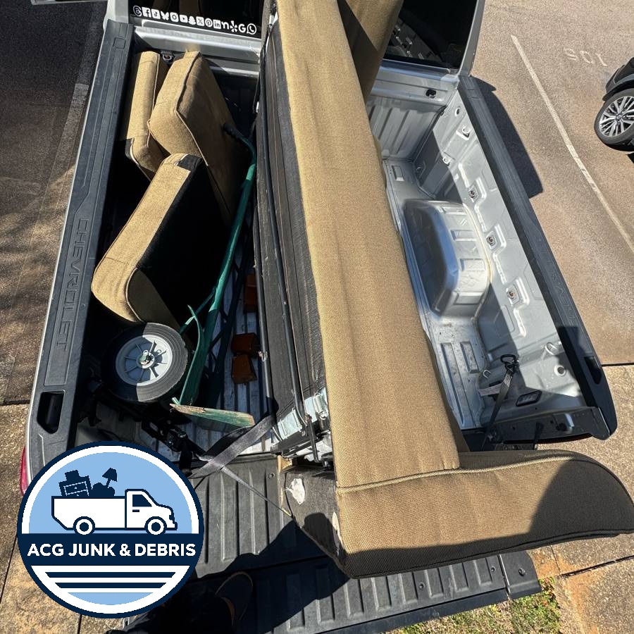 Couch loaded into company truck bed - Wake County furniture removal junk removal service